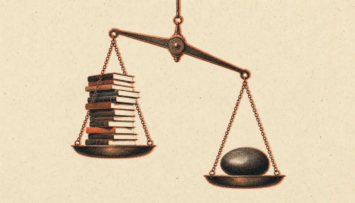 Brass scale weighing books against a stone to measure the knowledge action gap