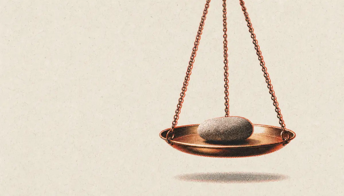 Brass scale weighing a single stone, symbolizing testing whether a personal code of conduct holds